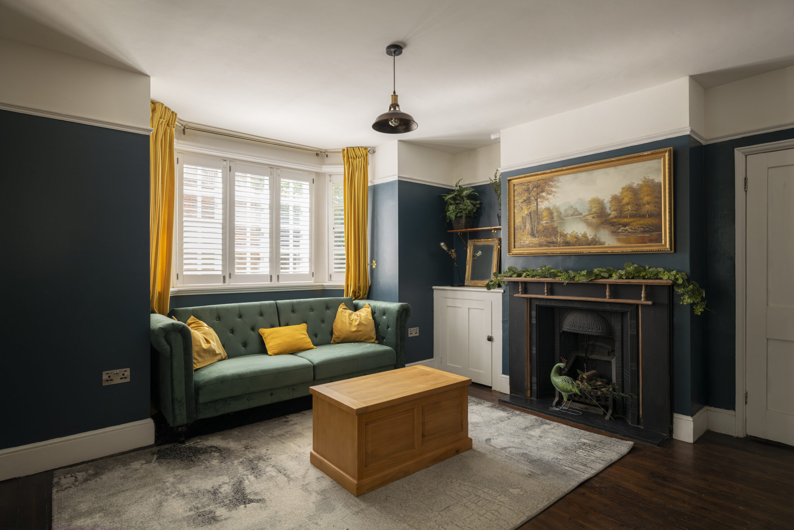 Cosy lounge area with sofa and fireplace at Lea Bridge Road